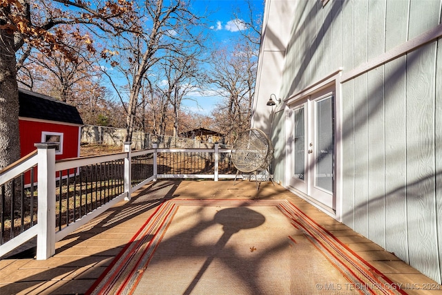 wooden terrace featuring a storage shed