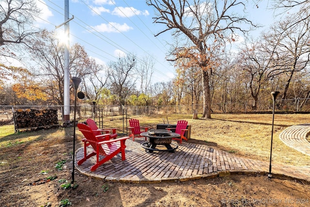 view of yard featuring a fire pit and a patio