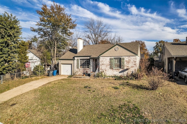 ranch-style house featuring a garage and a front lawn