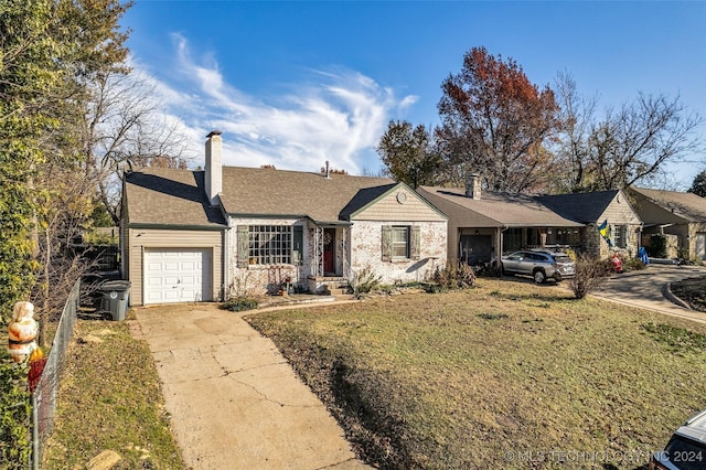 ranch-style home featuring a front yard and a garage