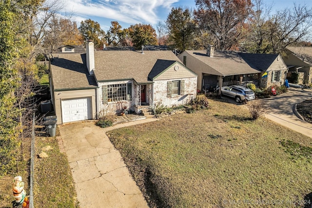 ranch-style house with a garage and a front lawn