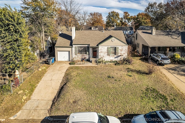 view of front of house with a garage and a front lawn