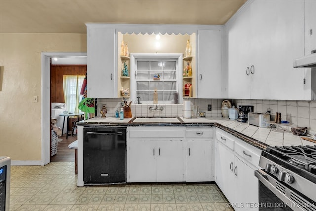 kitchen featuring sink, tasteful backsplash, stainless steel gas range oven, tile countertops, and white cabinets