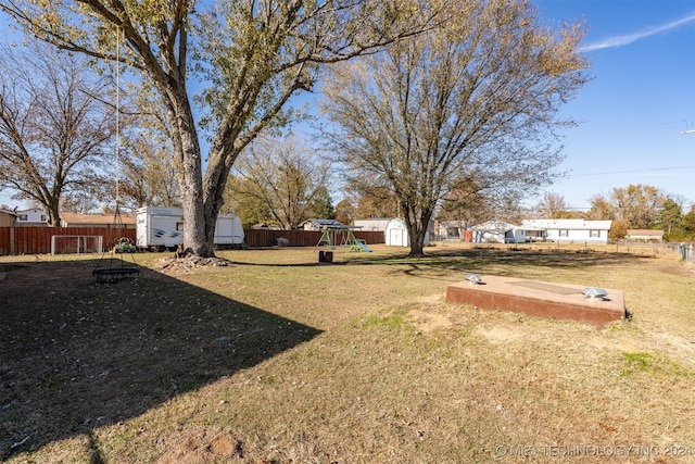 view of yard with a playground and a storage shed