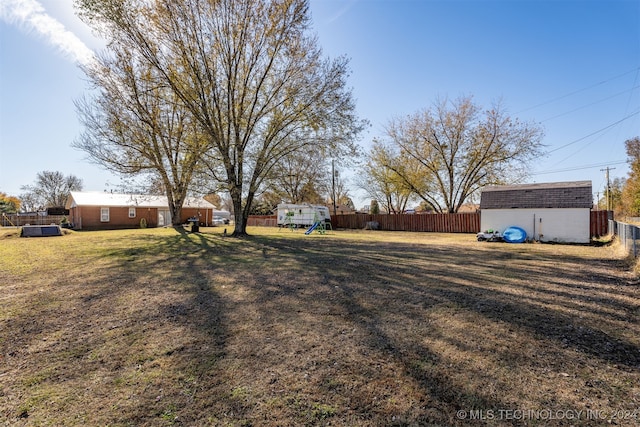 view of yard featuring a shed and a playground