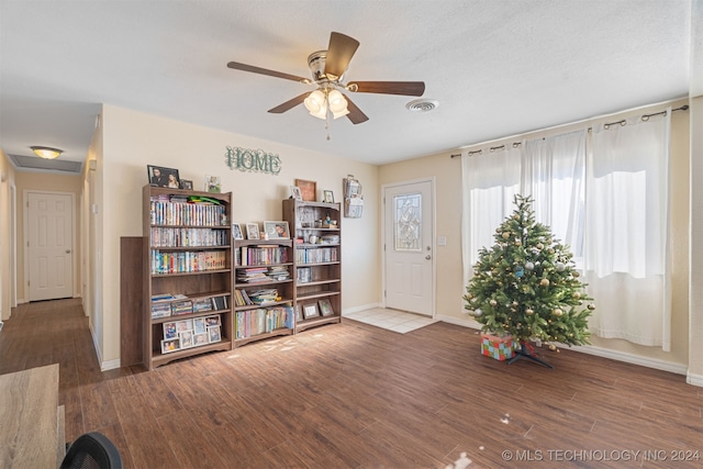 living area featuring ceiling fan and hardwood / wood-style flooring