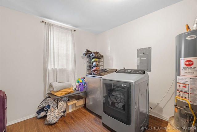 washroom with electric panel, water heater, washer and clothes dryer, and hardwood / wood-style floors