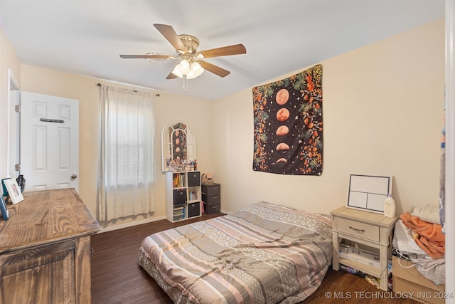 bedroom featuring ceiling fan and dark wood-type flooring