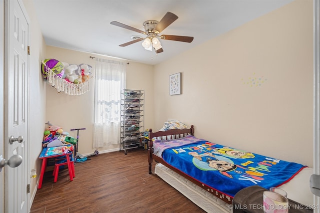 bedroom with dark hardwood / wood-style floors and ceiling fan