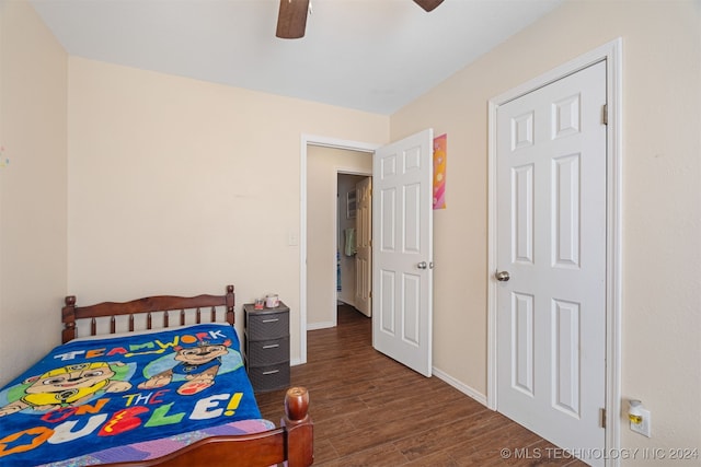 bedroom with dark hardwood / wood-style flooring and ceiling fan