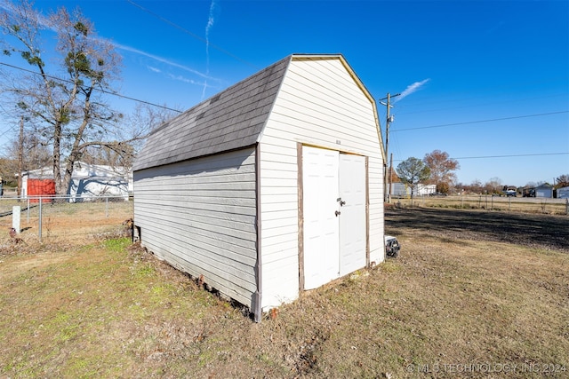 view of outbuilding featuring a lawn