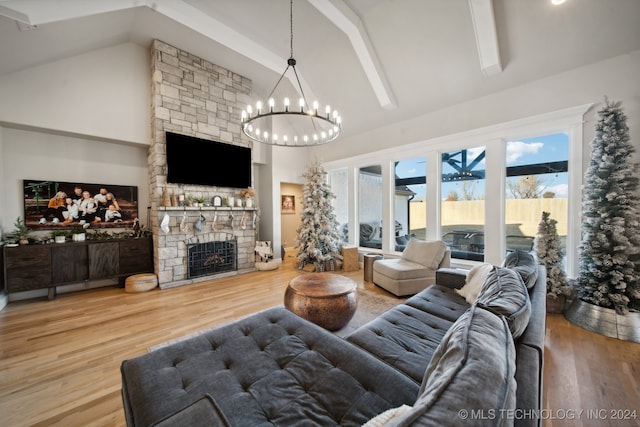 living room featuring a fireplace, high vaulted ceiling, a chandelier, and hardwood / wood-style flooring