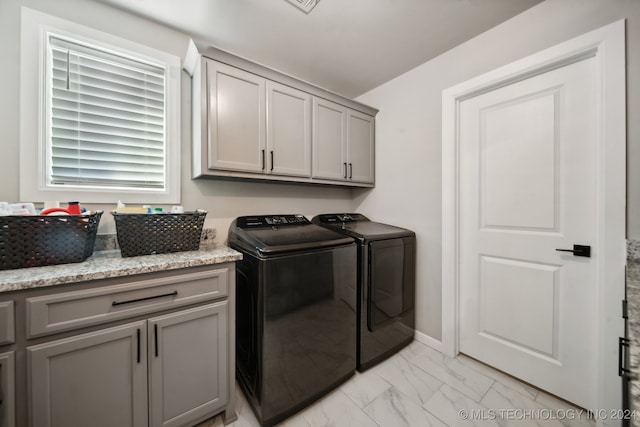 laundry room with cabinets and washing machine and dryer