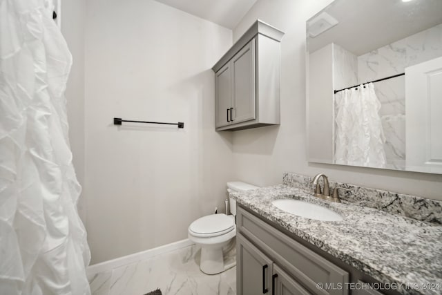 bathroom with vanity, toilet, and walk in shower