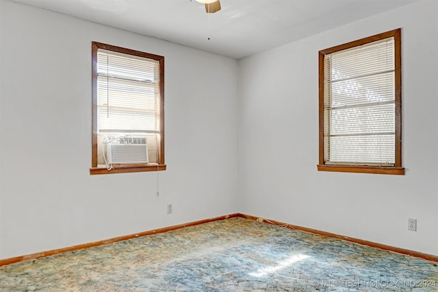 carpeted spare room with ceiling fan and cooling unit