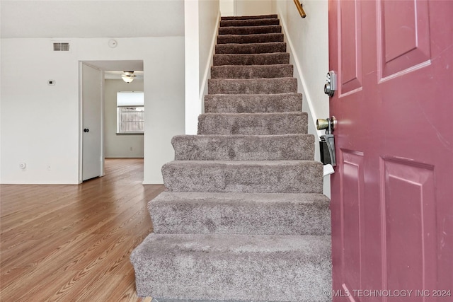 staircase featuring hardwood / wood-style flooring