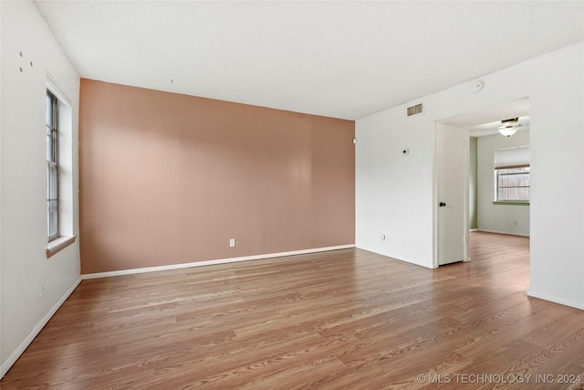 spare room with hardwood / wood-style flooring and ceiling fan