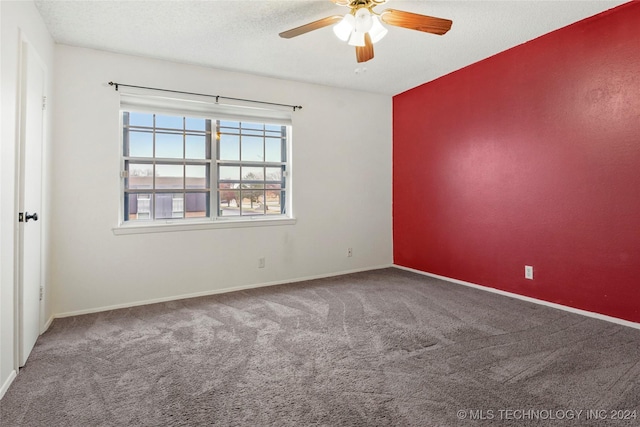 carpeted empty room featuring a textured ceiling and ceiling fan