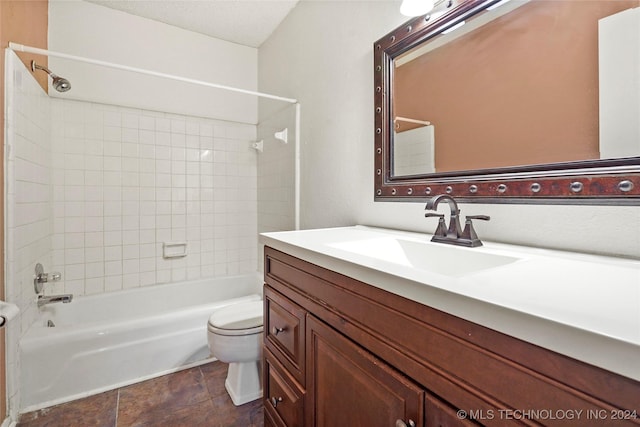 full bathroom featuring vanity, tiled shower / bath combo, and toilet