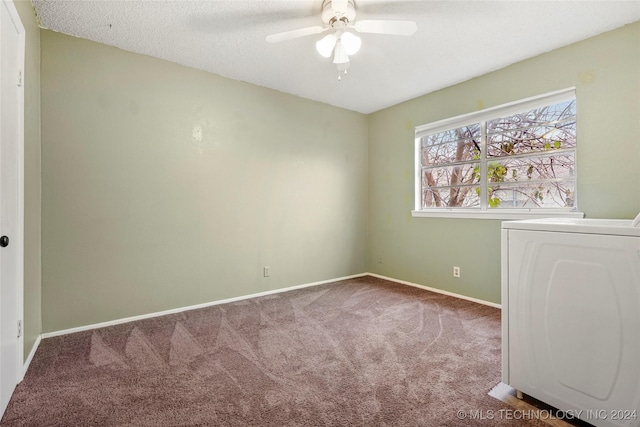 unfurnished room featuring ceiling fan, washer / dryer, carpet floors, and a textured ceiling