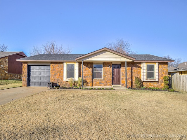 ranch-style home with a front yard and a garage