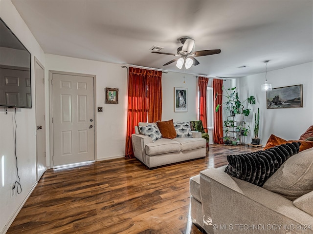 living room featuring ceiling fan and dark hardwood / wood-style flooring