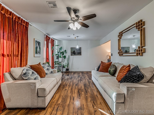 living room with ceiling fan and dark wood-type flooring