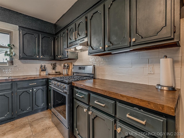 kitchen featuring wooden counters, decorative backsplash, and stainless steel range with gas cooktop