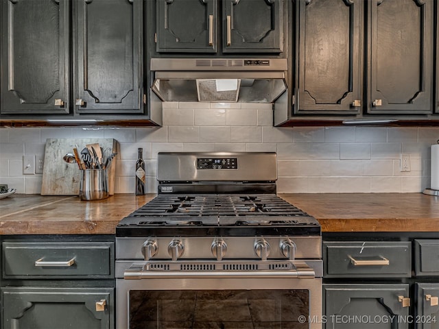 kitchen with gas stove, backsplash, extractor fan, and butcher block counters