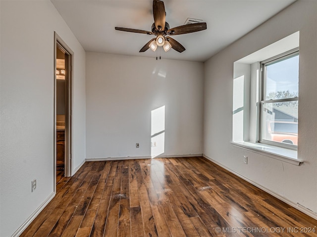 spare room with ceiling fan and dark wood-type flooring