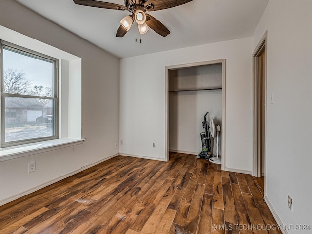 unfurnished bedroom featuring ceiling fan, dark hardwood / wood-style flooring, and a closet