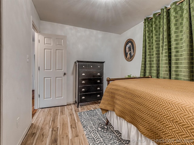 bedroom with hardwood / wood-style flooring