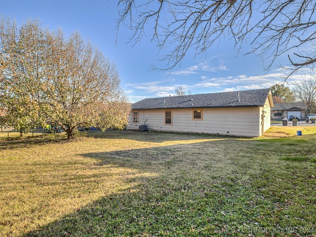 exterior space featuring a lawn and central AC