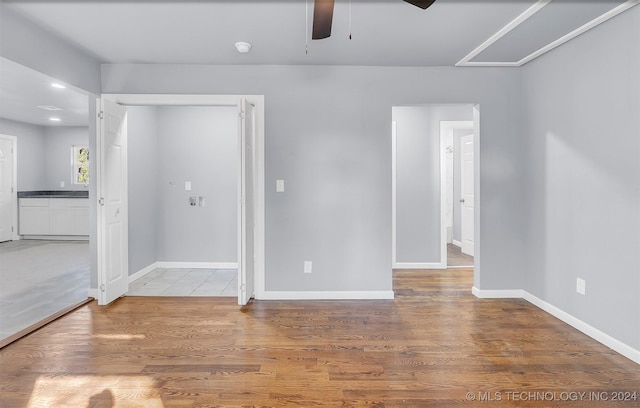 spare room with hardwood / wood-style flooring and ceiling fan