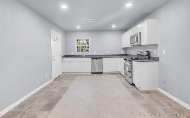 kitchen with white cabinets, stainless steel appliances, and sink