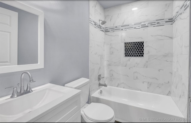 full bathroom with vanity, tiled shower / bath combo, and toilet