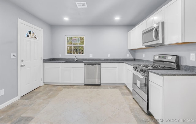 kitchen featuring sink, white cabinetry, and stainless steel appliances