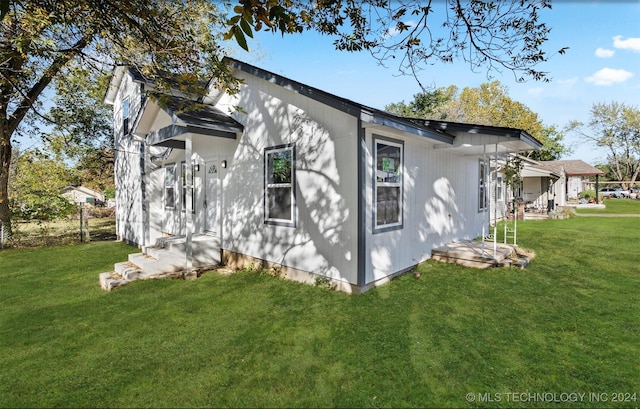 view of side of home featuring a yard