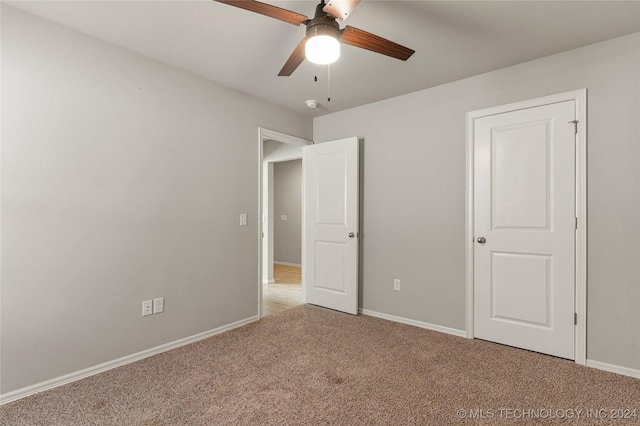 unfurnished bedroom featuring ceiling fan and light colored carpet