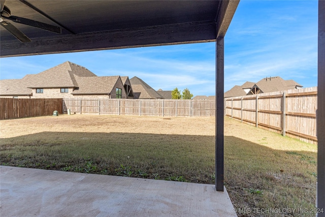 view of yard featuring ceiling fan and a patio area