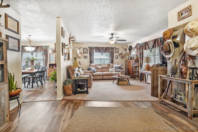 living room with wood-type flooring and a textured ceiling