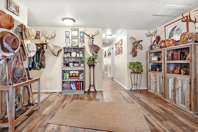 interior space featuring hardwood / wood-style flooring and a textured ceiling