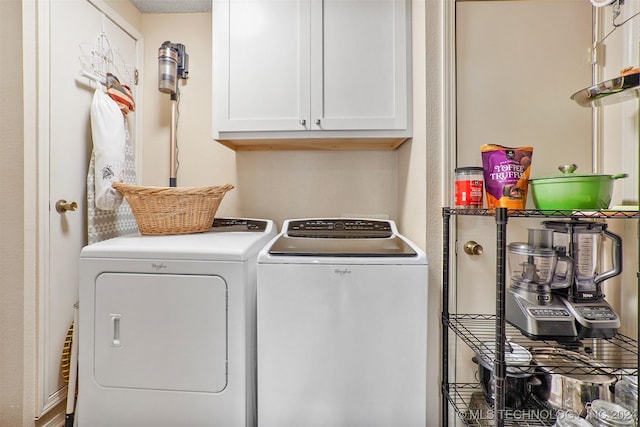 laundry area with washer and dryer and cabinets