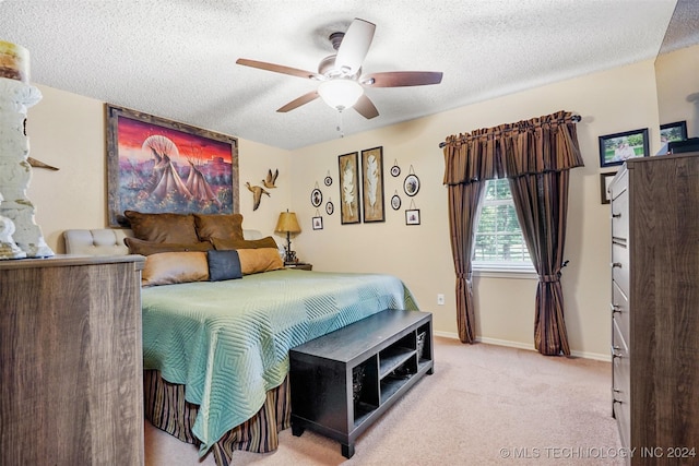 bedroom with light carpet, a textured ceiling, and ceiling fan