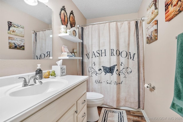 bathroom featuring vanity, a shower with shower curtain, toilet, a textured ceiling, and wood-type flooring