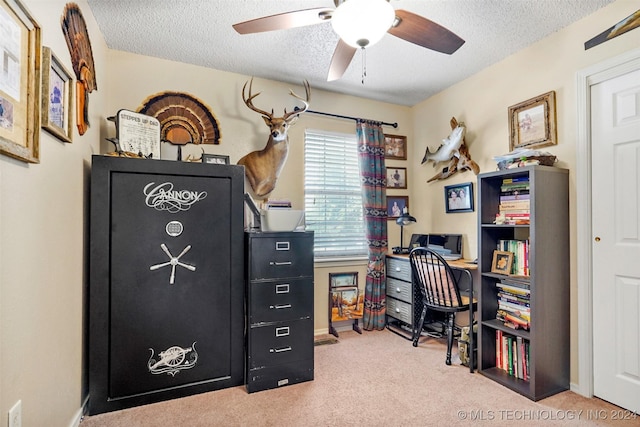 carpeted home office featuring ceiling fan and a textured ceiling