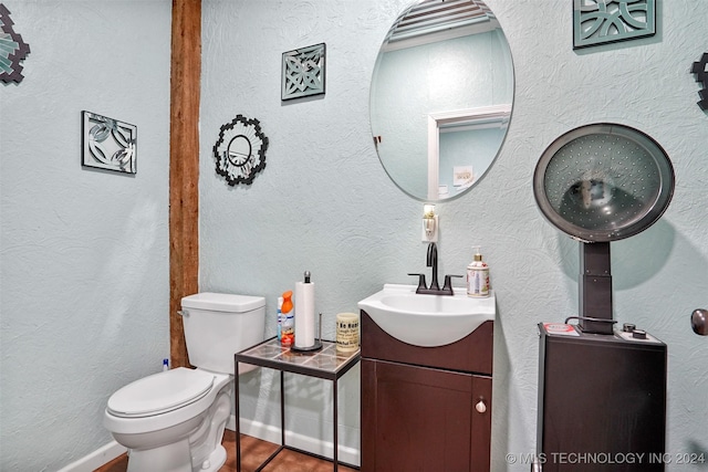 bathroom with tile patterned flooring, vanity, and toilet