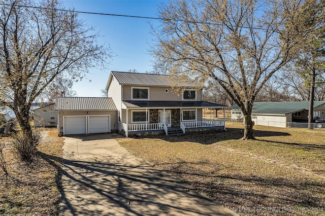 country-style home with a front yard, a porch, and a garage