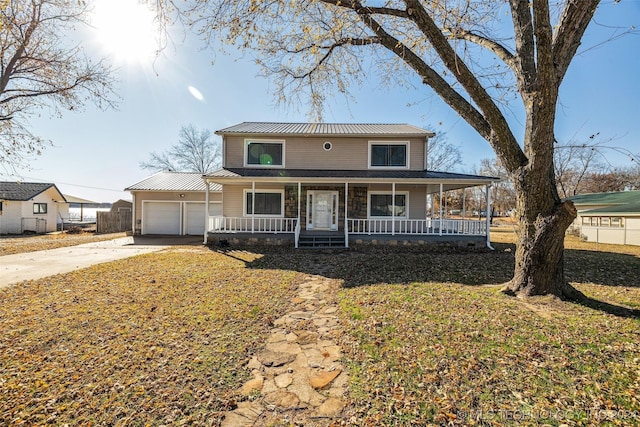 country-style home with an outdoor structure, a front lawn, a porch, and a garage