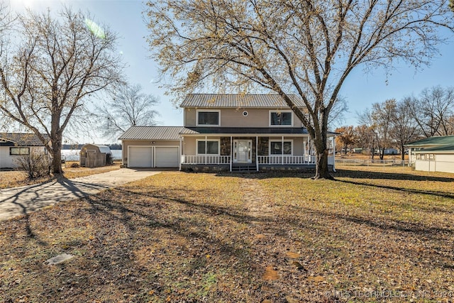 view of front of home featuring a garage, covered porch, and a front lawn